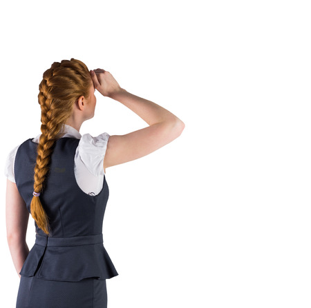 Redhead businesswoman standing and looking on white backgroundの写真素材