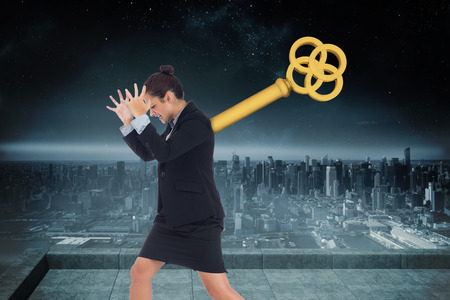 Wound up businesswoman gesturing against balcony overlooking cityの写真素材
