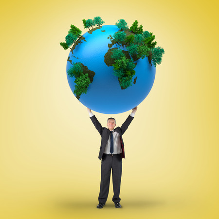 Composite image of businessman holding earth against yellow vignetteの写真素材