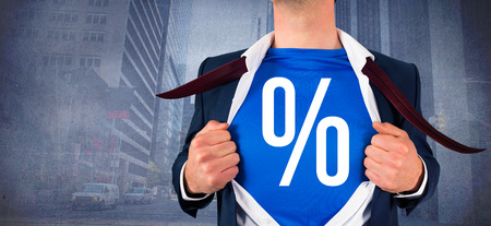 Businessman opening his shirt superhero style against urban projection on wallの写真素材
