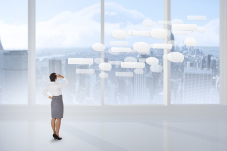 Businesswoman scratching her head against bright white room with windowsの写真素材