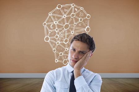 Upset thinking businessman against room with wooden floorの写真素材