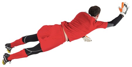 Fit goal keeper jumping up on white backgroundの写真素材