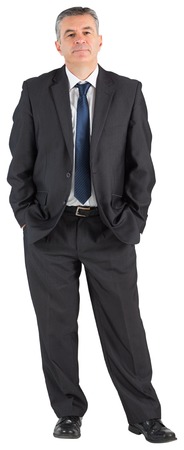 Mature businessman looking at camera on white backgroundの写真素材
