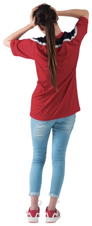 Football fan in red jersey with hands on head on white background