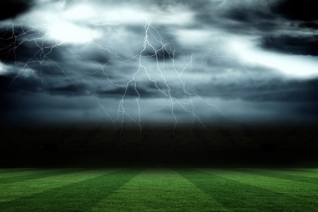Digitally generated football pitch under stormy skyの写真素材