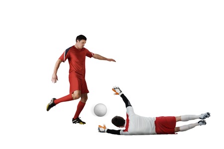 Football players tackling for the ball on white backgroundの写真素材