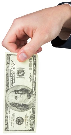 Hand holding hundred dollar bill on white background