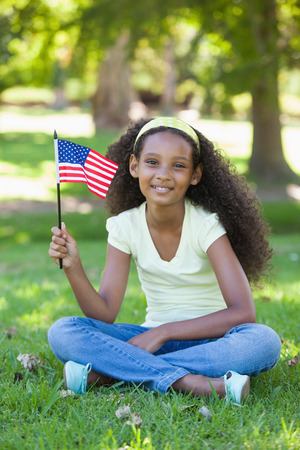 Young girl celebrating independence day in the park on a sunny dayの写真素材