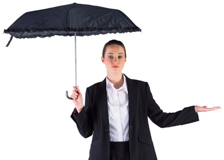 Businesswoman holding a black umbrella on white backgroundの写真素材