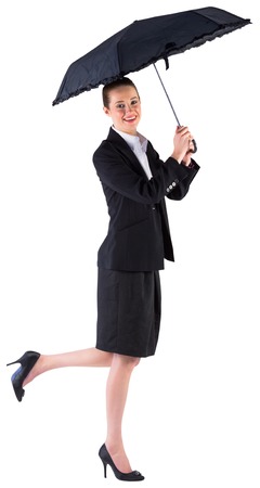 Businesswoman holding a black umbrella on white backgroundの写真素材