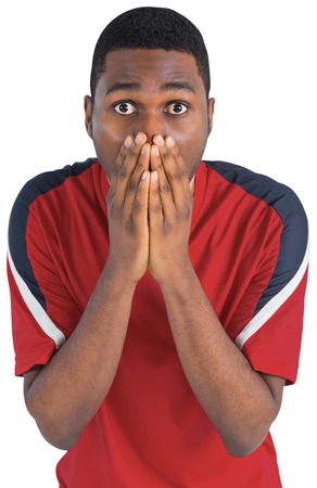 Nervous football fan looking ahead on white backgroundの写真素材