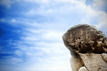 Digitally generated large rock overlooking bright skyの写真素材