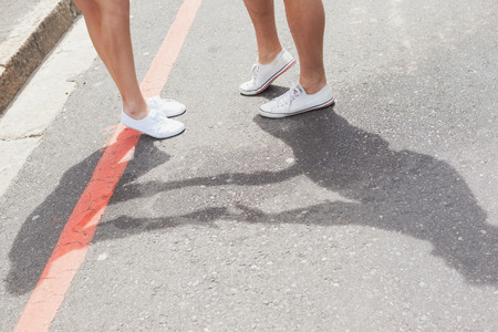 Couple standing on the road on a sunny day in the cityの写真素材