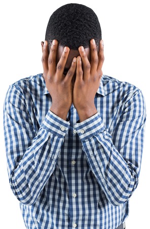 Young businessman with head in hands on white backgroundの写真素材