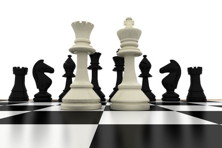 White king and queen standing in front of black pieces on white backgroundの写真素材