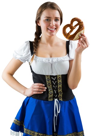 Pretty oktoberfest girl holding pretzel on white backgroundの写真素材