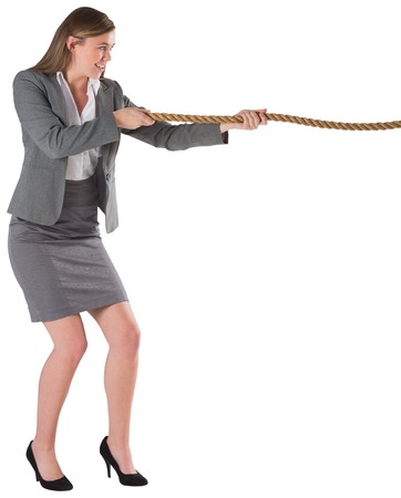 Businesswoman pulling a rope on white backgroundの写真素材