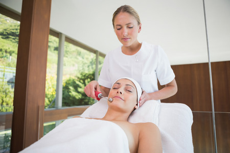 Peaceful brunette getting micro dermabrasion in the health spaの写真素材
