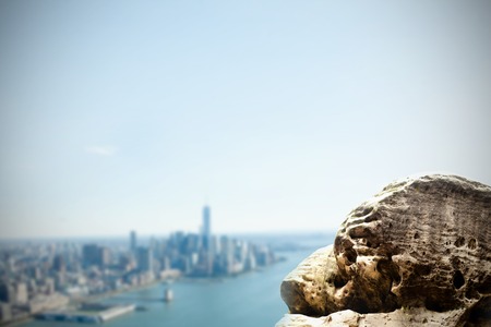 Digitally generated large rock overlooking coastline cityの写真素材