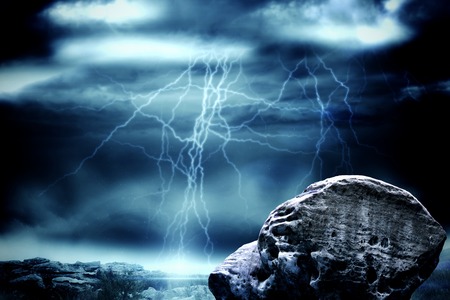 Digitally generated large rock overlooking stormy skyの写真素材