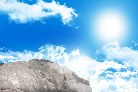 Digitally generated large rock overlooking blue skyの写真素材
