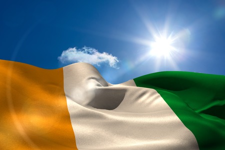 Digitally generated ivory coast national flag under sunny skyの写真素材