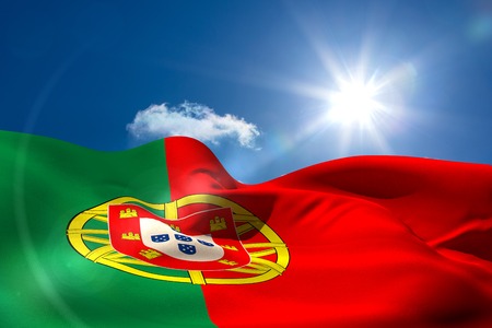 Digitally generated portugal national flag under sunny skyの写真素材