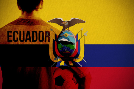 Ecuador football player holding ball against ecuador national flagの写真素材