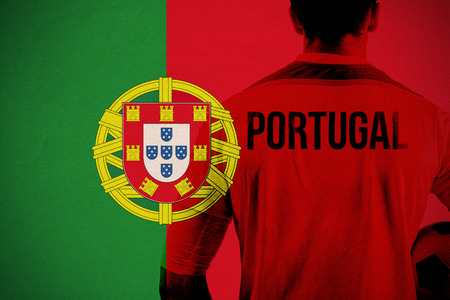 Portugal football player holding ball against portugal national flagの写真素材