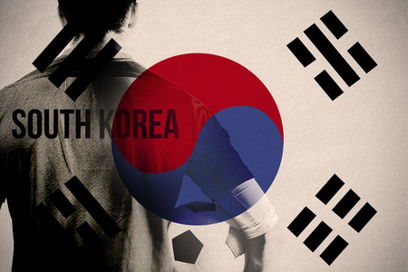 South korea football player holding ball against japan national flagの写真素材