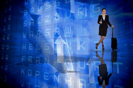 Businesswoman leaning on her suitcase holding tablet pc against blue departures board for major citiesの写真素材