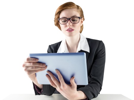 Redhead businesswoman using her tablet pc on white backgroundの写真素材