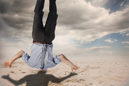 Businessman burying his head against cloudy sky background