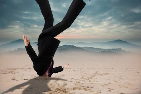 Businesswoman burying her head against scenic countryside with mountainsの写真素材