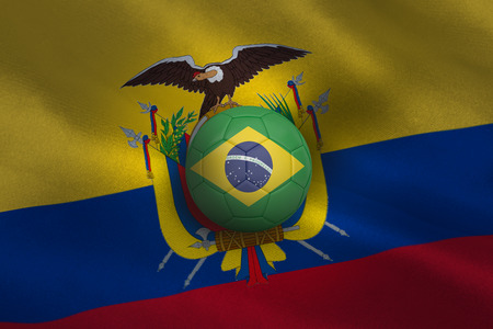 Football in brasil colours against ecuador flag backgroundの写真素材