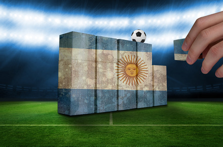 Hand building wall of argentina flag in grunge effectの写真素材