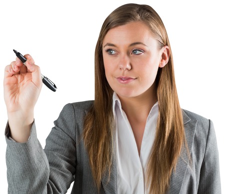 Smiling businesswoman writing with pen on white backgroundの写真素材