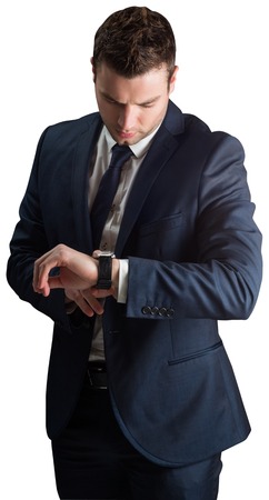 Handsome businessman checking the time on white backgroundの写真素材