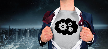 Businessman opening shirt in superhero style against balcony overlooking cityの写真素材