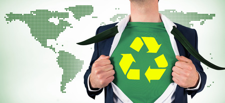 Businessman opening shirt in superhero style against green world map on white backgroundの写真素材