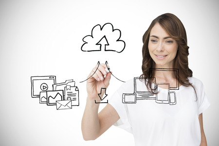 Businesswoman writing doodle against white background with vignetteの写真素材