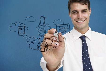 Businessman writing doodle against blue background with vignetteの写真素材