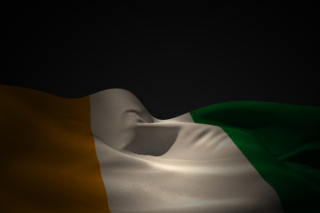 Ivory coast flag waving against black shadowの写真素材