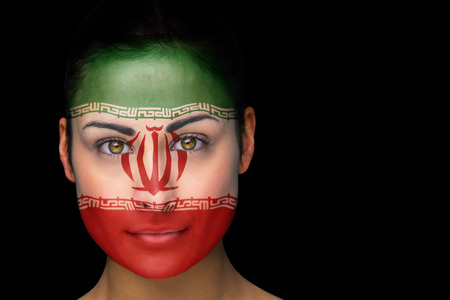 Composite image of iran football fan in face paint against blackの写真素材