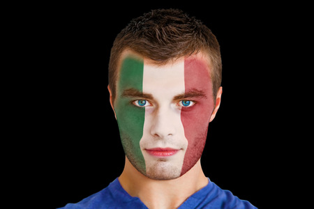 Composite image of serious young italy fan with facepaint against blackの写真素材