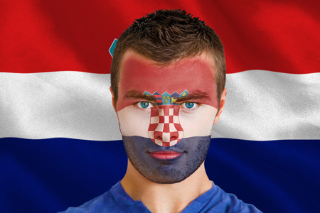 Composite image of serious young croatia fan with facepaint against digitally generated croatia national flagの写真素材