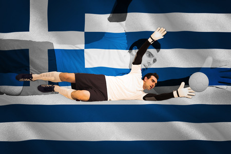 Goalkeeper in white making a save against digitally generated greek national flagの写真素材