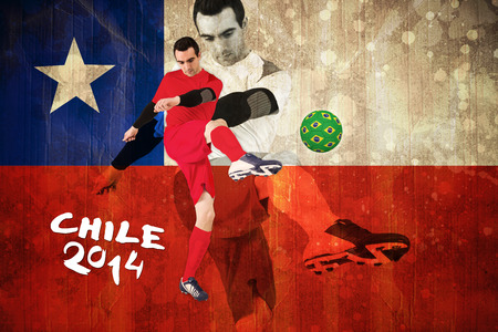 Football player in red kicking against chile flag in grunge effectの写真素材