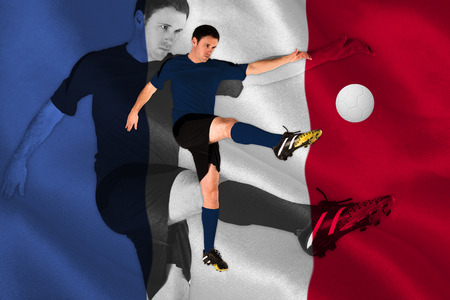 Football player in red kicking against digitally generated france national flagの写真素材